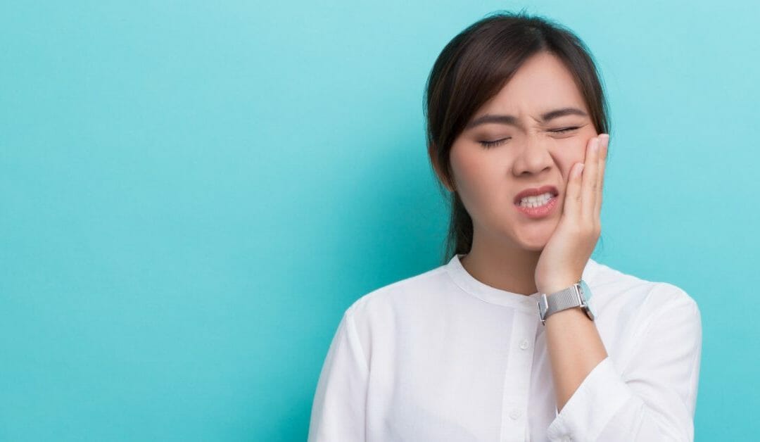 Woman Holding Face in Pain