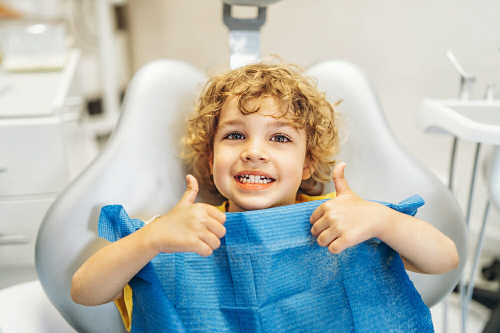 Boy In Dentist Chair Giving Thumbs Up
